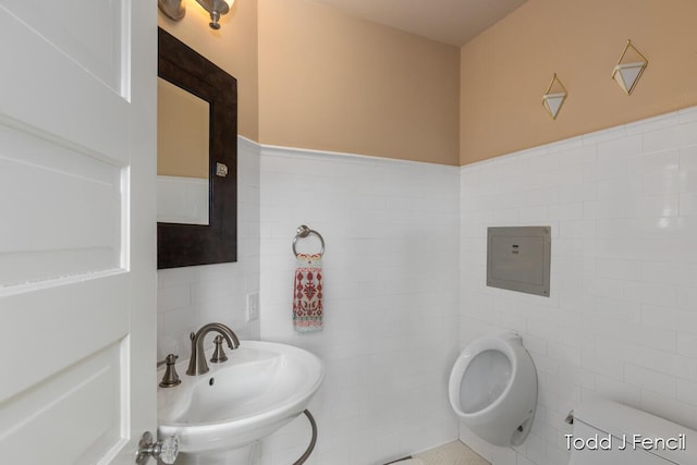 554 Madison Ave SE, Grand Rapids, MI 49503 - half bathroom featuring tile walls, a sink, and toilet