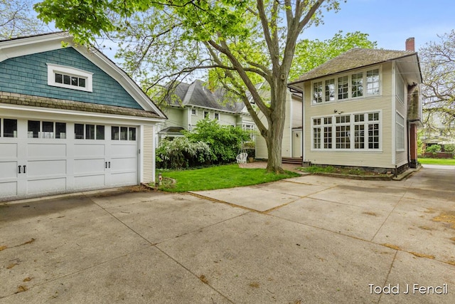554 Madison Ave SE, Grand Rapids, MI 49503 - view of property exterior with a chimney and a lawn