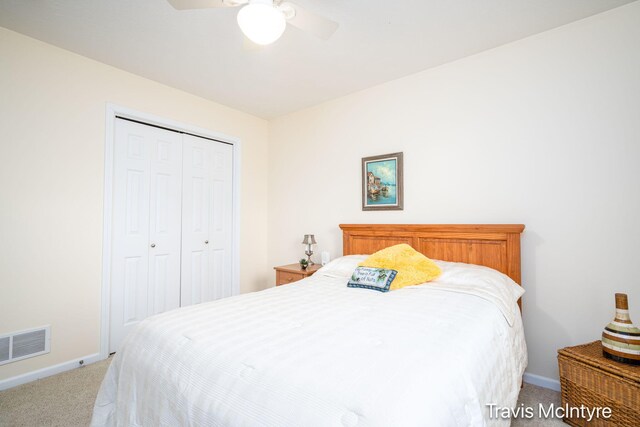 carpeted bedroom with a closet, baseboards, and ceiling fan
