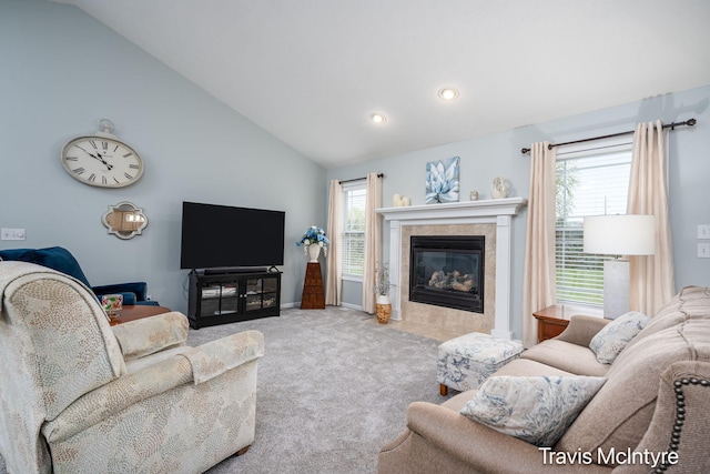 living area featuring lofted ceiling, a tile fireplace, carpet floors, recessed lighting, and baseboards