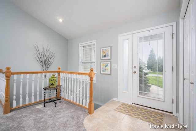 foyer with baseboards, lofted ceiling, and recessed lighting