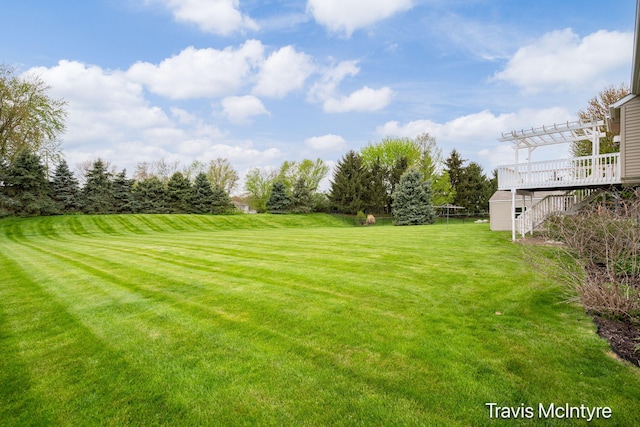 view of grassy yard with a pergola