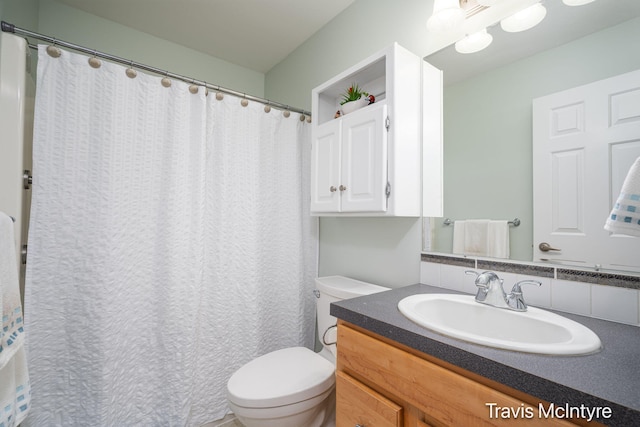 bathroom featuring toilet and vanity