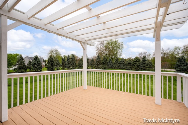 wooden deck featuring a pergola and a yard