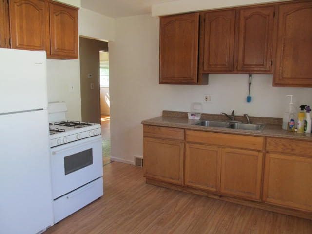 18478 Fox, Redford, MI 48240 - kitchen featuring white appliances, a sink, brown cabinets, and light wood finished floors