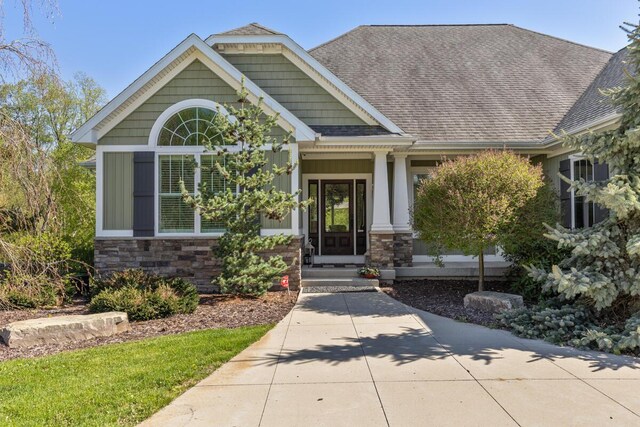 9510 Sparta Ave NW, Sparta, MI 49345 - craftsman-style home featuring stone siding and a shingled roof