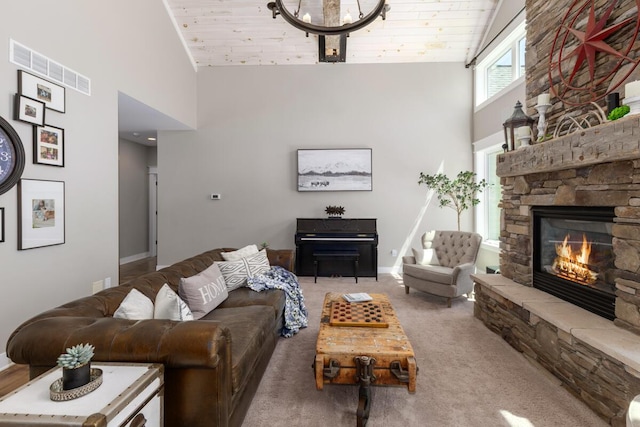 9510 Sparta Ave NW, Sparta, MI 49345 - living room featuring high vaulted ceiling, a stone fireplace, baseboards, carpet, and a chandelier