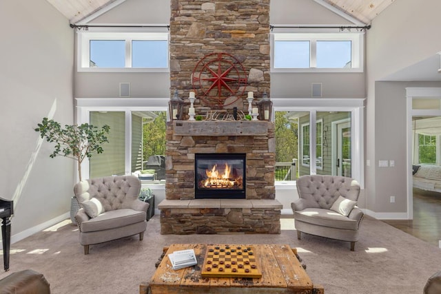 9510 Sparta Ave NW, Sparta, MI 49345 - living area with high vaulted ceiling, a stone fireplace, and baseboards