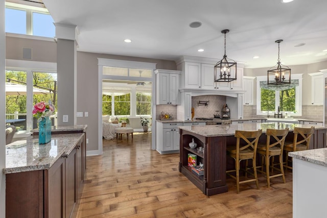 9510 Sparta Ave NW, Sparta, MI 49345 - kitchen featuring backsplash, light wood-style flooring, white cabinetry, and recessed lighting