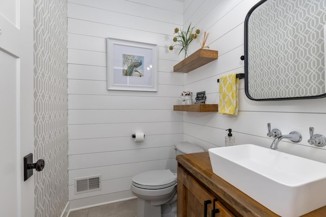9510 Sparta Ave NW, Sparta, MI 49345 - bathroom featuring toilet, vanity, and wood walls