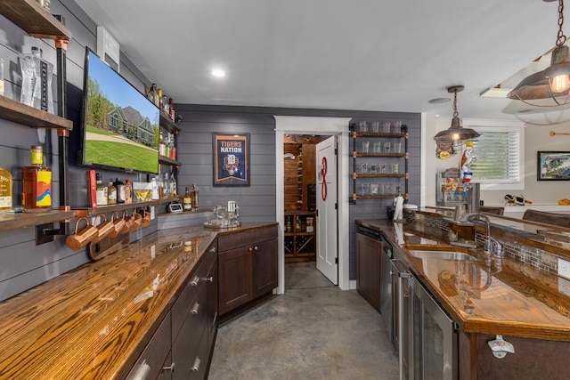 9510 Sparta Ave NW, Sparta, MI 49345 - indoor wet bar featuring wine cooler, concrete flooring, and hanging light fixtures