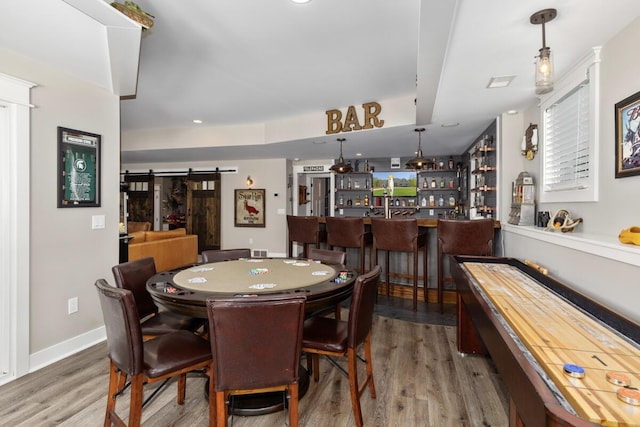 9510 Sparta Ave NW, Sparta, MI 49345 - dining room featuring a bar, wood finished floors, and a barn door