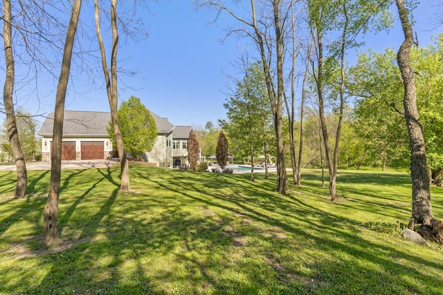 9510 Sparta Ave NW, Sparta, MI 49345 - view of green lawn featuring concrete driveway