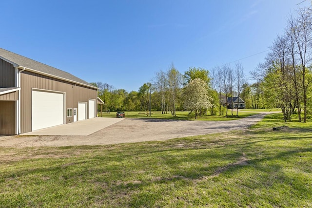 9510 Sparta Ave NW, Sparta, MI 49345 - view of green lawn featuring an outdoor structure and a garage