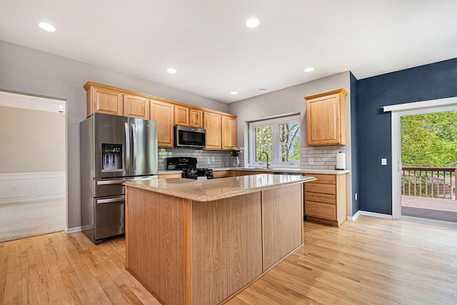 2570 Black Horse Ct NE, Grand Rapids, MI 49505 - kitchen featuring appliances with stainless steel finishes, a kitchen island, decorative backsplash, light wood-style floors, and recessed lighting