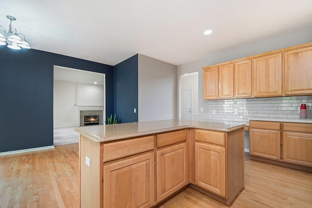 2570 Black Horse Ct NE, Grand Rapids, MI 49505 - kitchen with light wood-style floors, decorative backsplash, light countertops, light brown cabinets, and recessed lighting