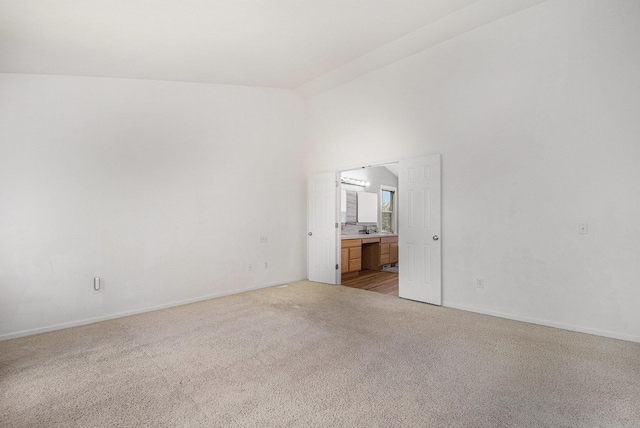 2570 Black Horse Ct NE, Grand Rapids, MI 49505 - unfurnished room featuring light colored carpet, baseboards, and high vaulted ceiling