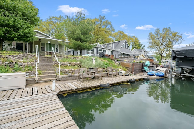 dock area with stairway and a water view