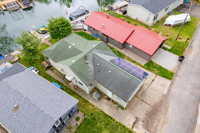 aerial view of property and surrounding area with a large body of water