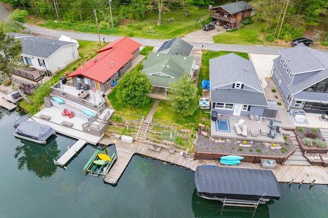 aerial view of residential area featuring a nearby body of water