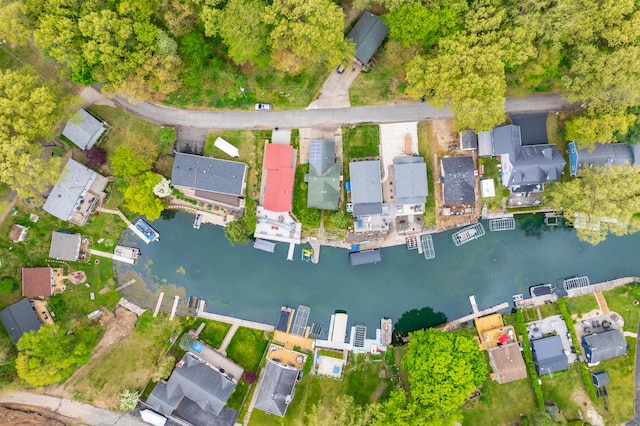 aerial overview of property's location with a nearby body of water and nearby suburban area