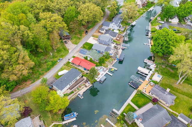 aerial view of property and surrounding area with a nearby body of water
