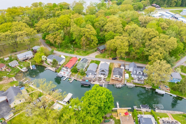aerial view of property and surrounding area featuring a large body of water and nearby suburban area