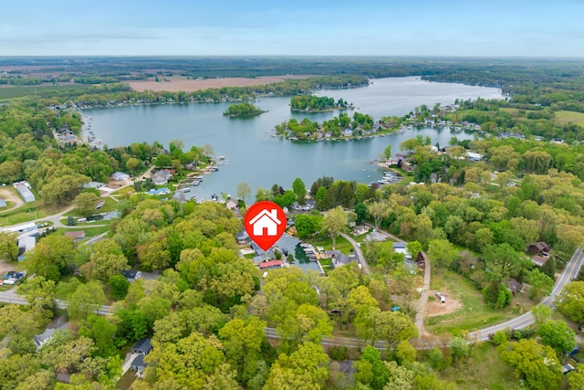 aerial view of property's location featuring a large body of water and a forest