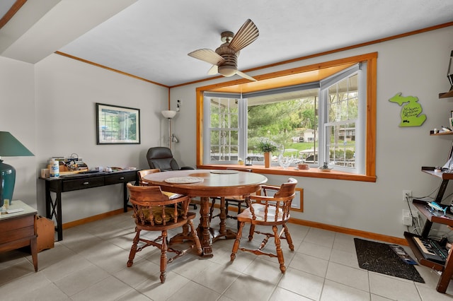 dining room with a ceiling fan, crown molding, baseboards, light tile patterned floors, and an office area