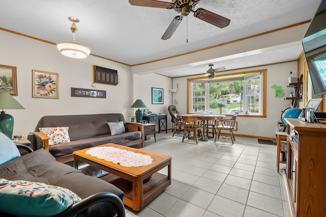 living room with a ceiling fan, ornamental molding, light tile patterned flooring, baseboards, and a textured ceiling