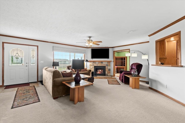 living room featuring crown molding, carpet, a ceiling fan, a fireplace, and baseboards