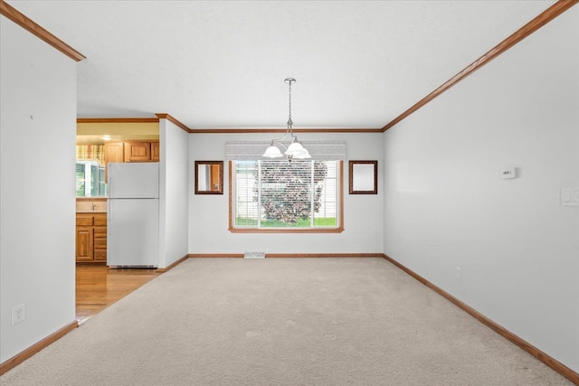 unfurnished dining area with light colored carpet, baseboards, plenty of natural light, and ornamental molding