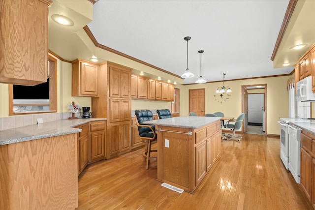 kitchen with crown molding, a center island, white appliances, light wood-style flooring, and a breakfast bar area
