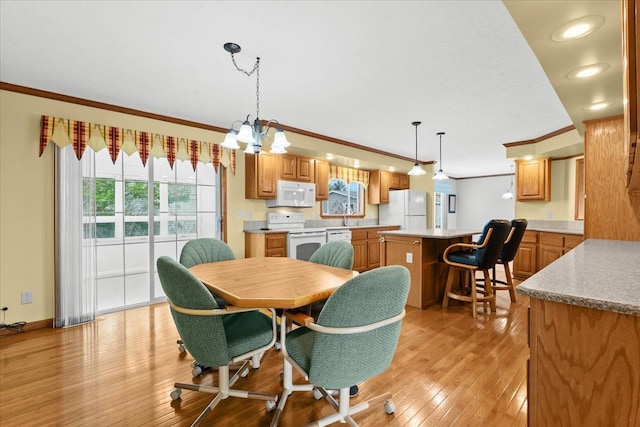 dining area with ornamental molding, light wood finished floors, a chandelier, baseboards, and recessed lighting