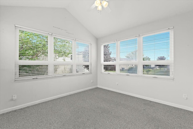 spare room with baseboards, vaulted ceiling, a ceiling fan, and carpet flooring