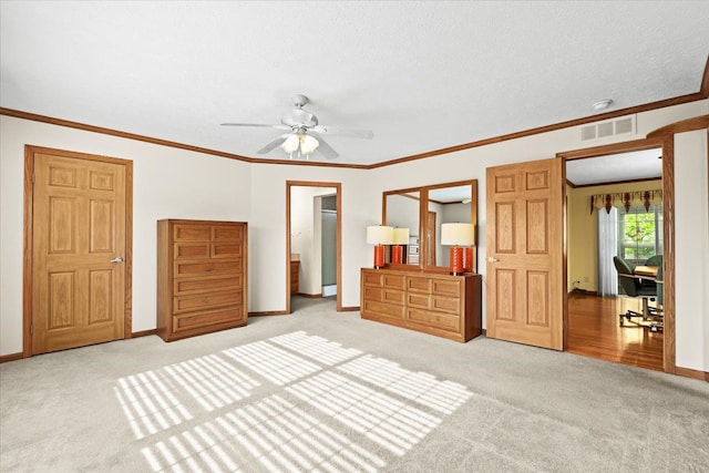 unfurnished bedroom featuring light carpet, baseboards, crown molding, and a ceiling fan