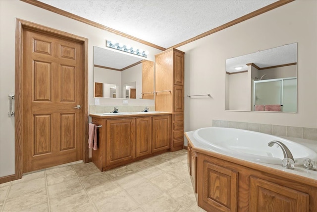 bathroom featuring crown molding, a garden tub, a stall shower, vanity, and a textured ceiling