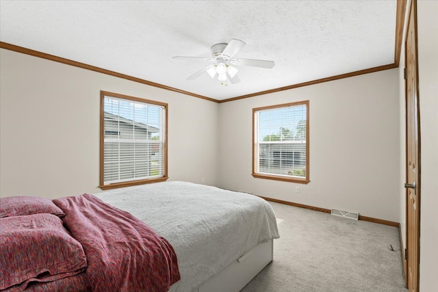 bedroom featuring multiple windows, baseboards, light colored carpet, ornamental molding, and a ceiling fan