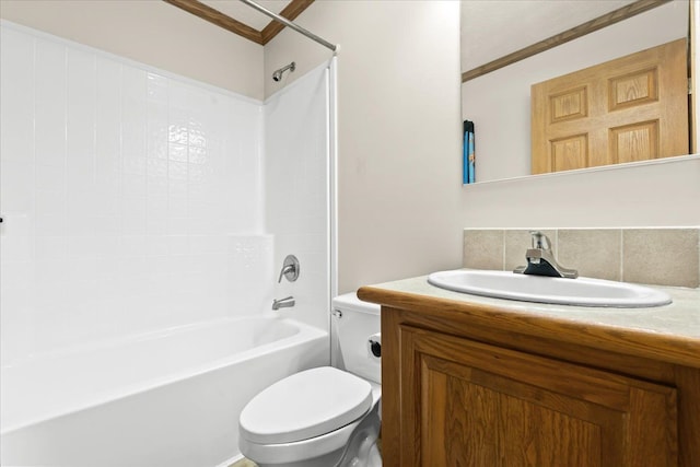 bathroom featuring toilet, shower / tub combination, vanity, and ornamental molding