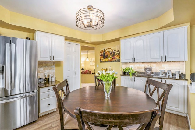 dining space with a chandelier and light wood-style flooring