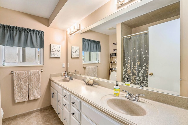 bathroom featuring tile patterned flooring, curtained shower, double vanity, toilet, and baseboards