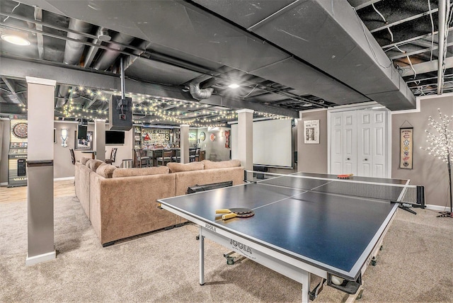 rec room with carpet flooring, bar, and baseboards