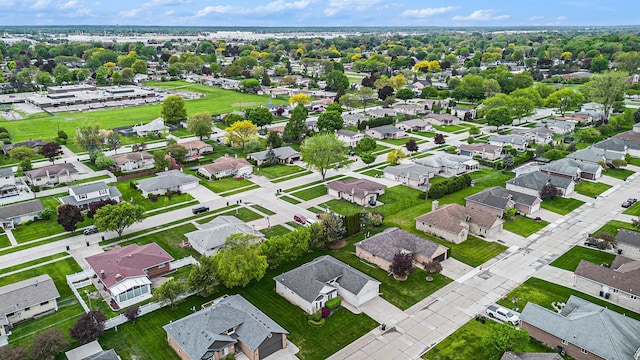 aerial view of property and surrounding area featuring nearby suburban area