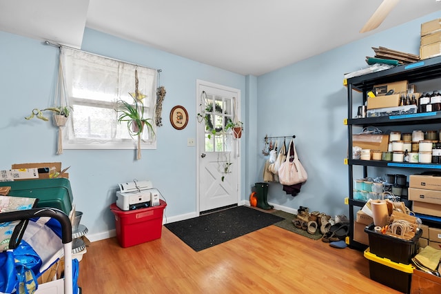 foyer featuring wood finished floors and baseboards
