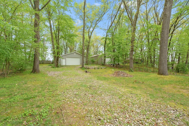 view of yard featuring an outbuilding and a detached garage