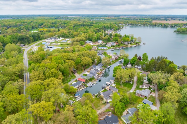 aerial overview of property's location featuring a nearby body of water and a heavily wooded area