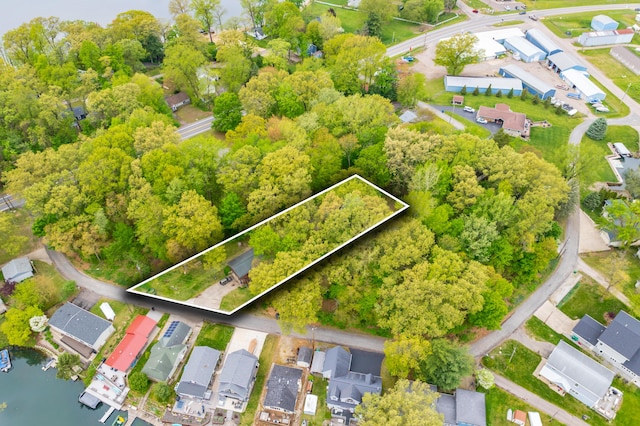 aerial view of property's location featuring property parcel outlined and nearby suburban area