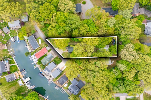 aerial view of residential area featuring property parcel outlined and a nearby body of water