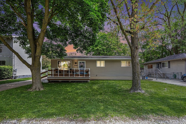 44080 Davis, Utica, MI 48317 - view of front of property with a wooden deck and a lawn