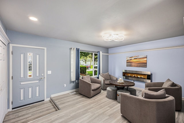 44080 Davis, Utica, MI 48317 - living area featuring a lit fireplace, light wood-style flooring, baseboards, and recessed lighting
